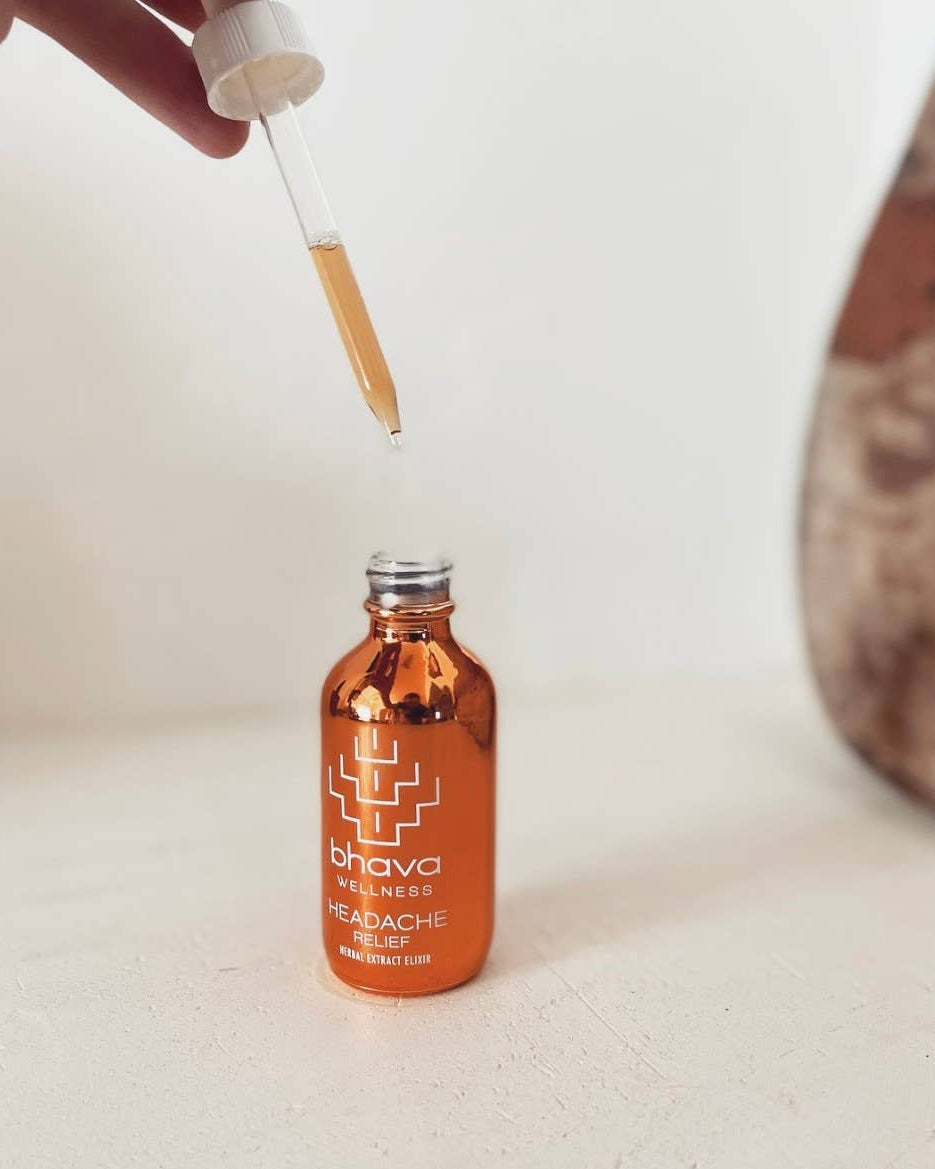 Orange bottle of Bhava Wellness Headache Relief with a dropper on a light surface.