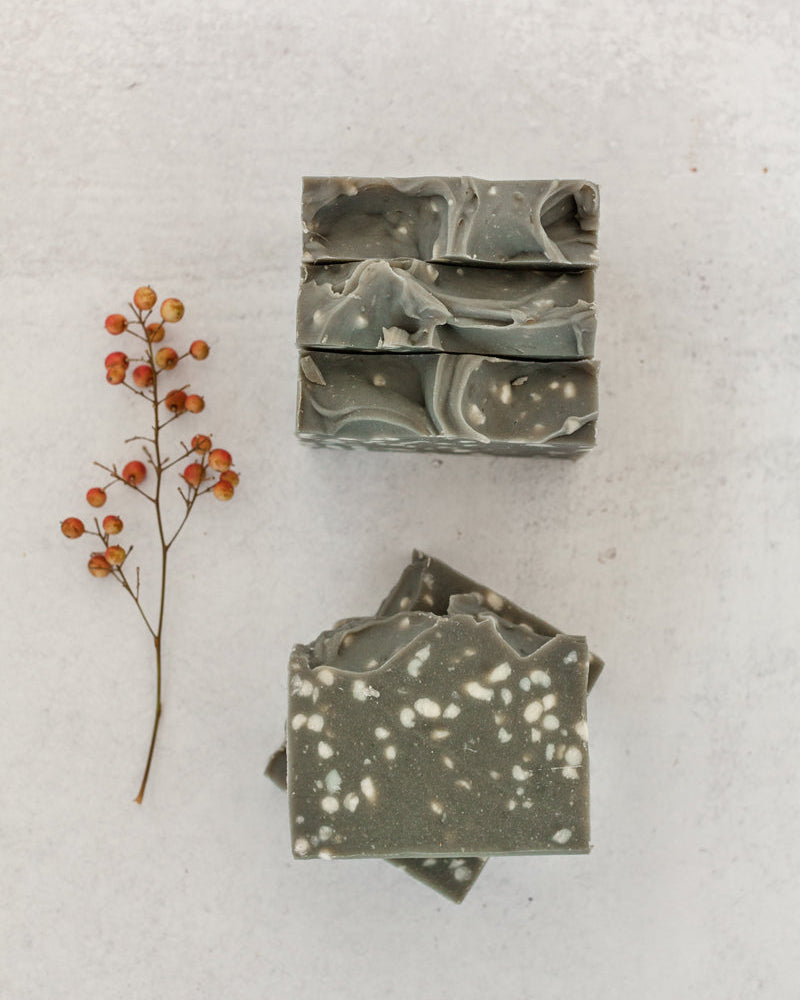 Nightfall soap bar in dark forest green with white speckles, winter inspired