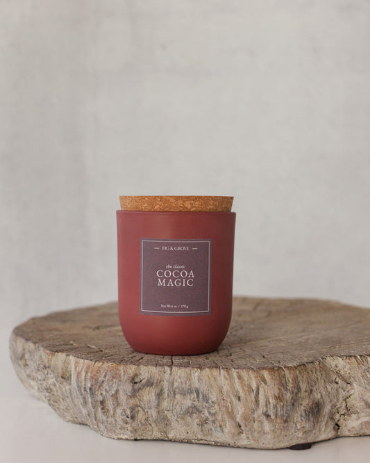 Cocoa Magic candle in umber glass jar on neutral background, evoking cocoa and coffee tones – Fig & Grove