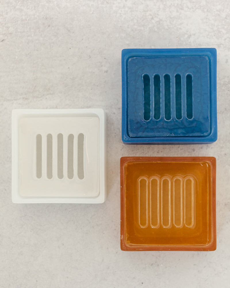 Cobalt blue, terracotta and white dishwashing soap dishes