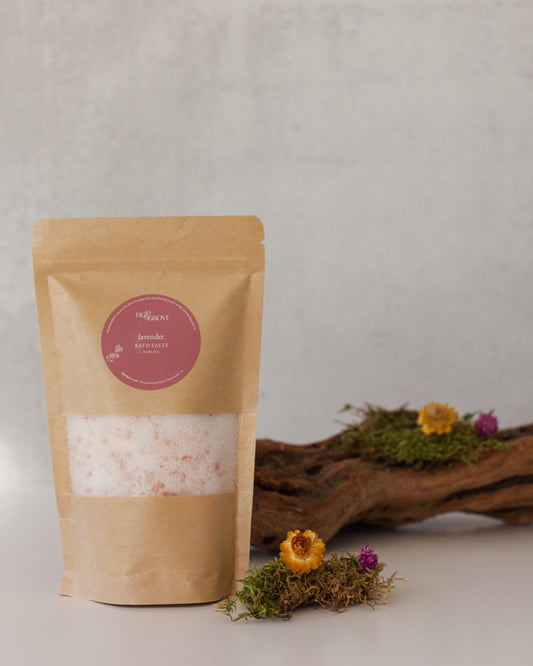 Lavender bath salts in a Kraft resealable pouch with a pink label on a neutral background with decorative elements - Fig & Grove