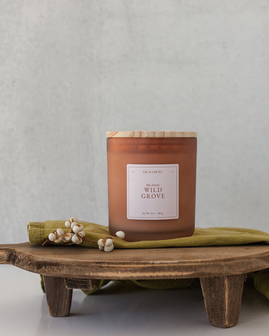 Wild Grove candle by Fig & Grove, featuring a minimalist label and natural wax, with calming scents of palo santo, lavender, and sage.